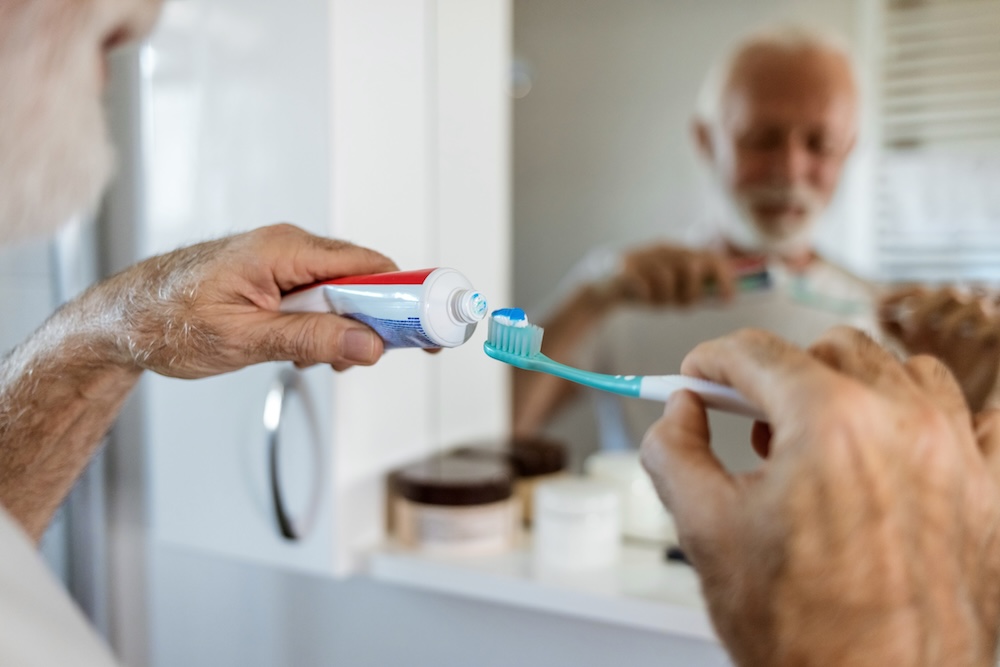 Cleaning, mouth or hand brushing teeth with dental toothpaste for healthy oral hygiene grooming. Eco friendly, senior man with a natural toothbrush for teeth whitening.